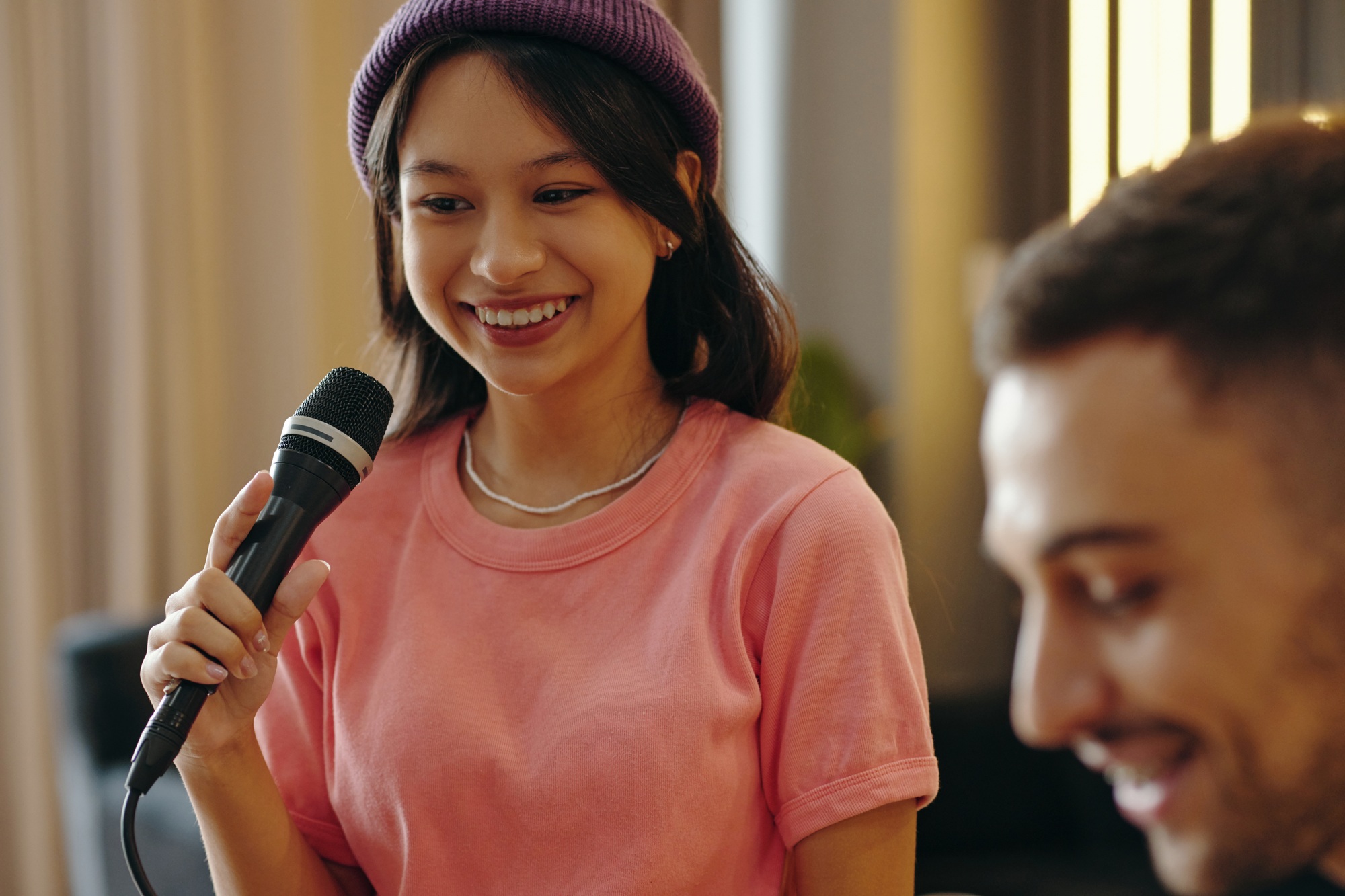 Smiling Woman Holding Microphone During Evening Event
